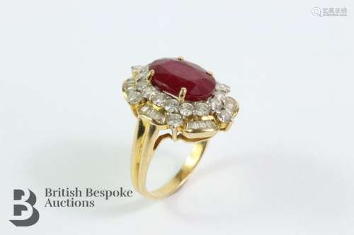 18ct yellow gold diamond and ruby ring. The oval ruby measur...