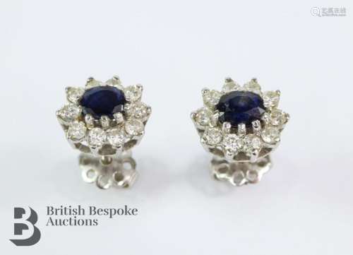 Pair of white gold midnight-blue sapphire and diamond earrin...