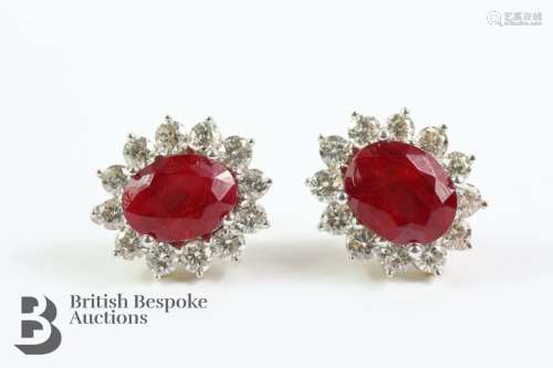 Pair of 14ct gold and ruby earrings. The earrings set with o...