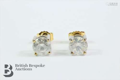 Pair of white gold solitaire diamond earrings. Each earring ...