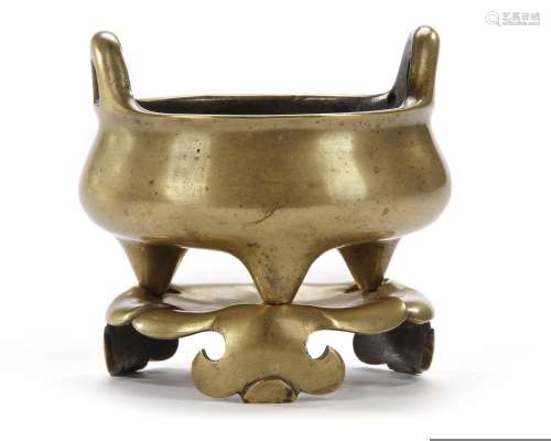 A GILT CHINESE TRIPOD BRONZE CENSER AND A STAND, 18TH-19TH C...