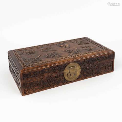 A Chinese chest with wood-sculptures 'Treasures of Buddhism'...