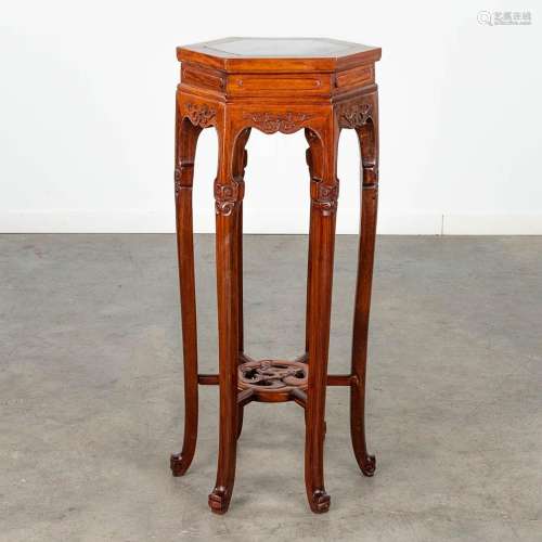 A Chinese hardwood stand with a black and white marble top. ...