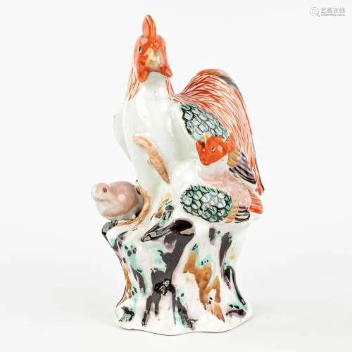 A Japanese porcelain figurative Chicken and her chicks. Porc...