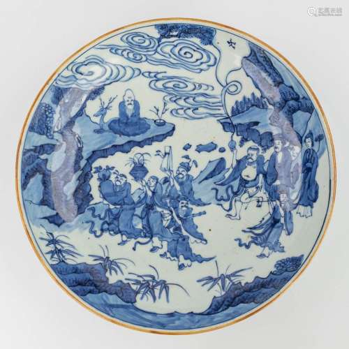 A Chinese blue-white plate decorated with wise figurines. 19...