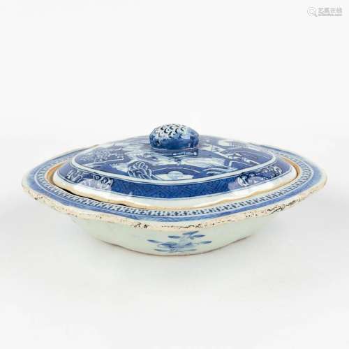 A Chinese bowl with a lid and blue-white landscape decor. 19...