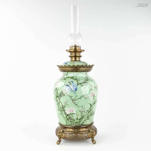 A Chinese celadon porcelain oil lamp, decorated with birds a...