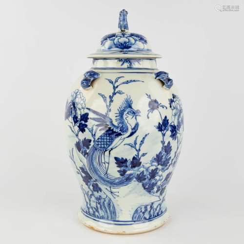 A Chinese vase with lid, blue-white decor with a phoenix and...