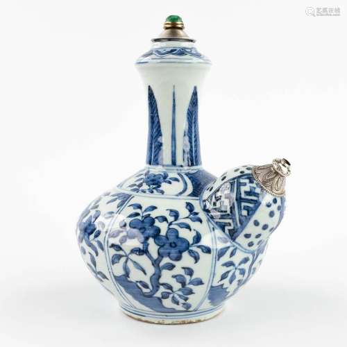 A Chinese water bottle 'Kendi' with blue-white decor and sil...