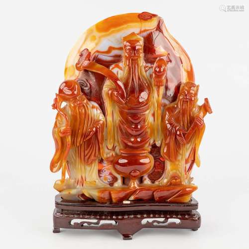 A large Chinese sculptured agate stone, decorated with three...