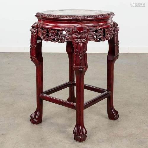 An Oriental stand, hardwood and decorated with a marble top....