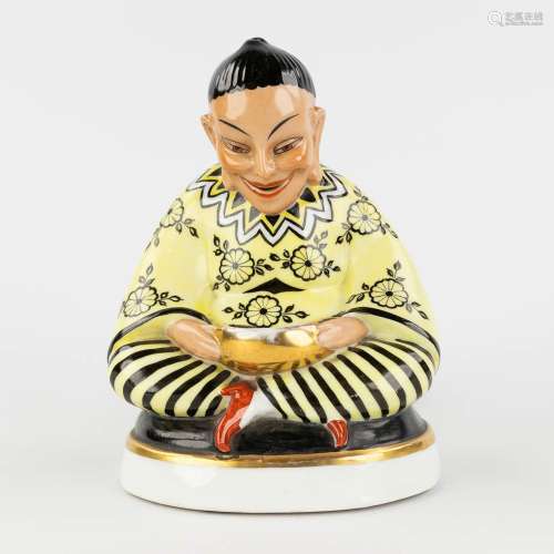 An insence burner in the shape of a Chinese figurine, interi...