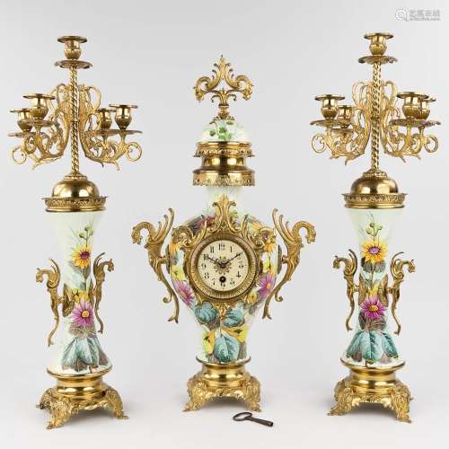 A three-piece mantle garniture clock and candelabra, circa 1...