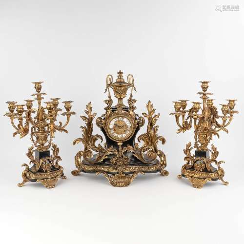 A three-piece mantle garniture clock and candelabra, Louis X...