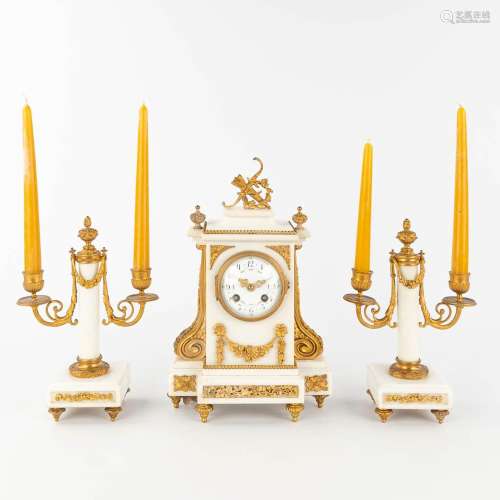 A three-piece mantle garniture clock and candelabra, white C...