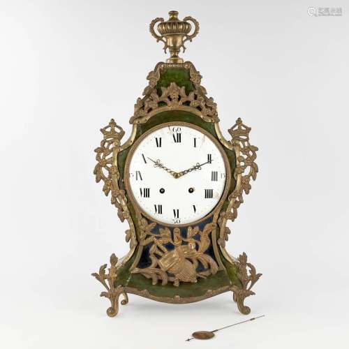 An antique Kartel clock, wood mounted with bronze and floral...