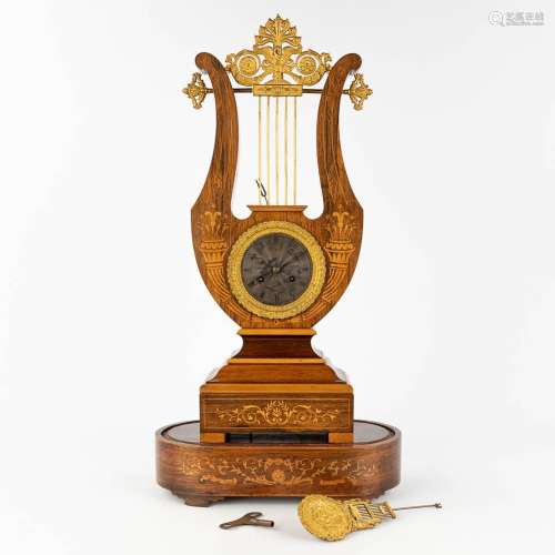 An antique Lyre mantle clock, Marquetry inlayed wood mounted...