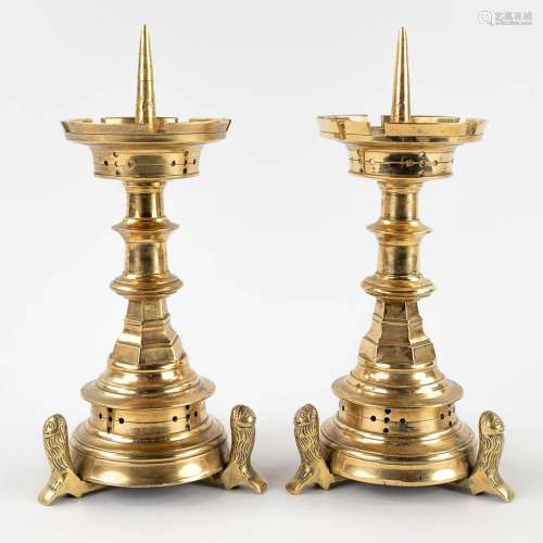 A pair of church candlesticks, bronze standing on lion's. 19...