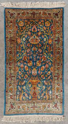 An Oriental hand-made carpet, Silk, Ghoum. Signed. (L: 108 x...