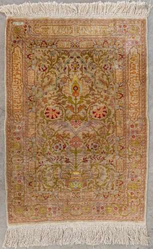 An Oriental hand-made carpet, silk. (L: 92 x W: 62 cm)