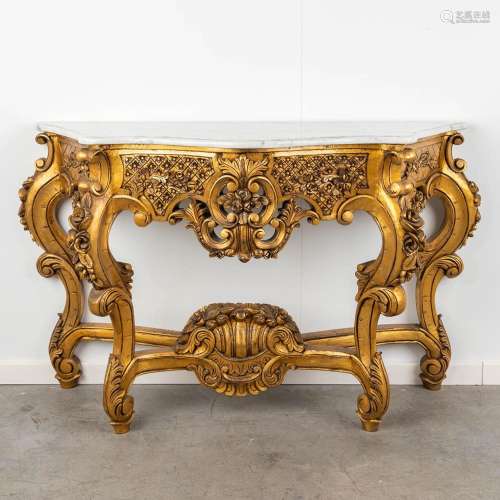 A wood sculptured console table with marble top, circa 1970....