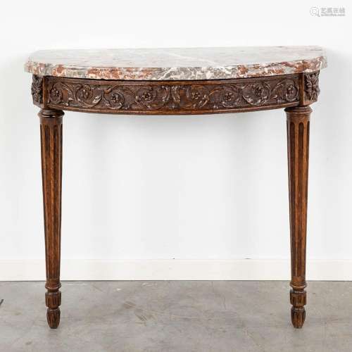 A wood-sculptured console table with a marble top. 18th C. (...