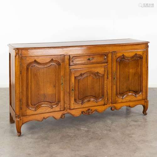 An antique sideboard, oak in Louis XV style. 19th century. (...