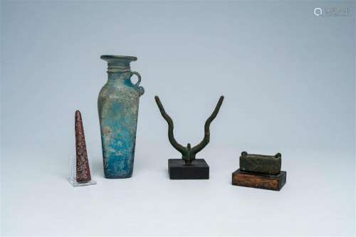 A varied collection of archaeological finds and a blue glass...