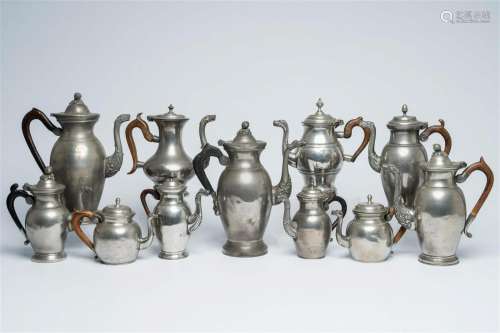 Eleven various pewter Empire 'dragon spout' jugs with wood h...