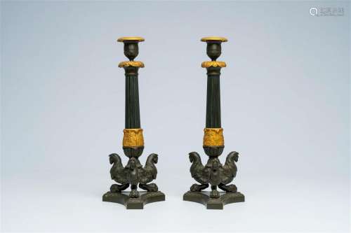 A pair of French gilt and patinated bronze 'griffins' candle...