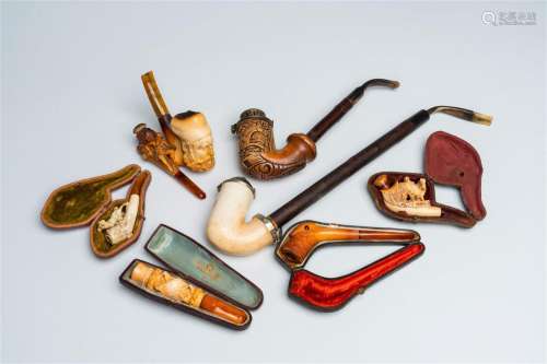 A varied collection of meerschaum pipes with different depic...