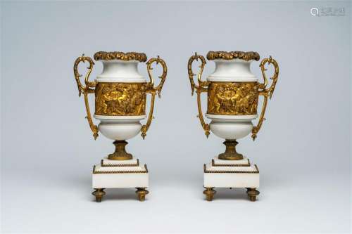 A pair of French gilt mounted white marble vases with relief...
