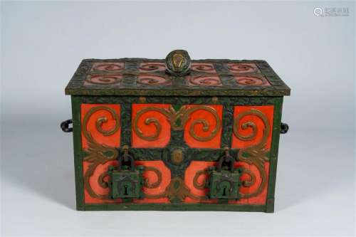 A polychrome painted safe-box with floral design and mascaro...