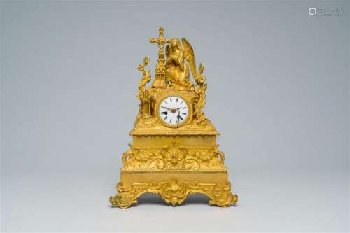 A French gilt bronze mantel clock topped with an angel, 19th...