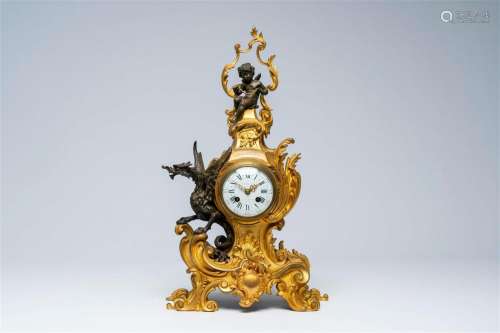 A French gilt and patinated bronze mantel clock with a winge...