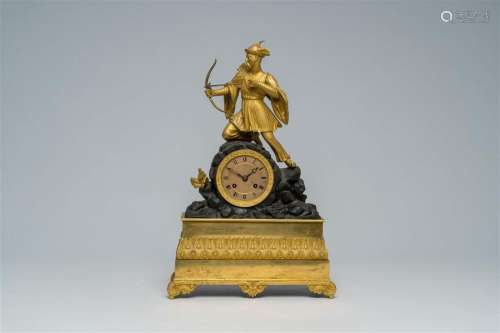 A French gilt and patinated bronze mantel clock topped with ...