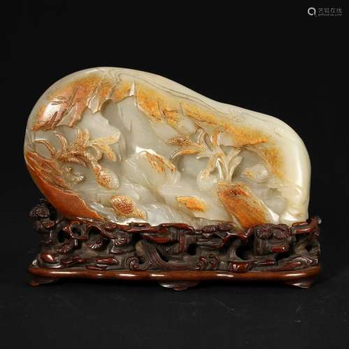 A WHITE AND RUSSET JADE BOULDER