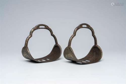 A pair of Tibetan or Mongolian silver inlaid iron stirrups, ...