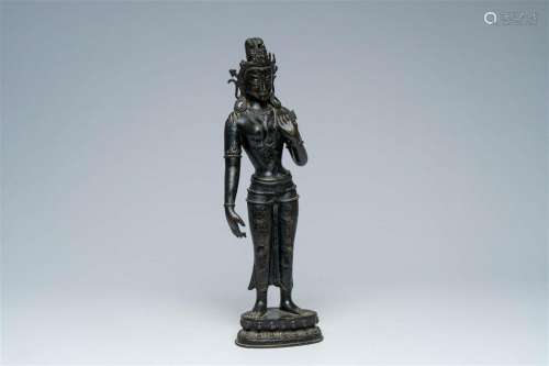 A large Nepalese patinated bronze figure of a standing Tara ...