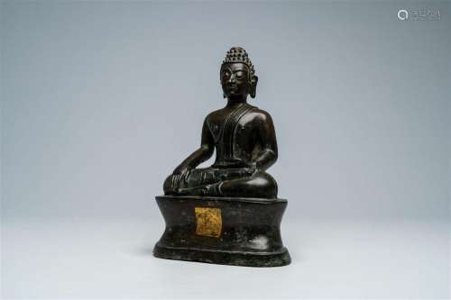 A Thai patinated bronze figure of a seated Buddha, possibly ...