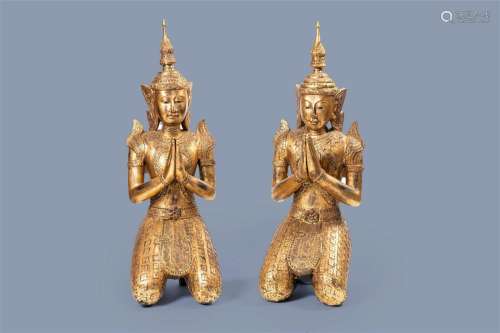 A pair of tall inlaid gilt wood figures of a kneeling Buddha...