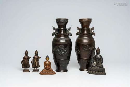 A pair of Japanese bronze vases with relief design and four ...