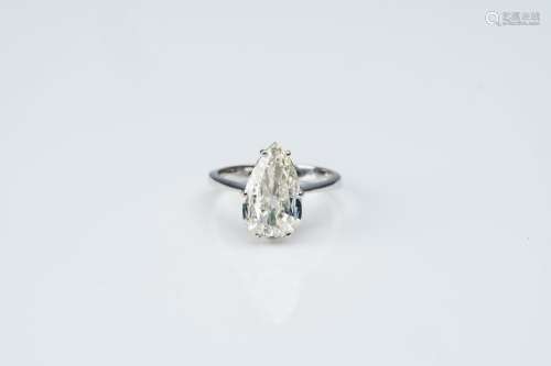 An 18 carat white gold ring set with a pear-shaped diamond, ...