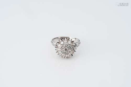 An 18 carat white gold ring set with nineteen diamonds, 20th...