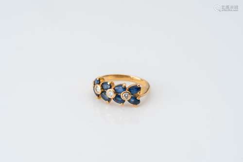 An 18 carat yellow gold ring set with eight sapphires and th...