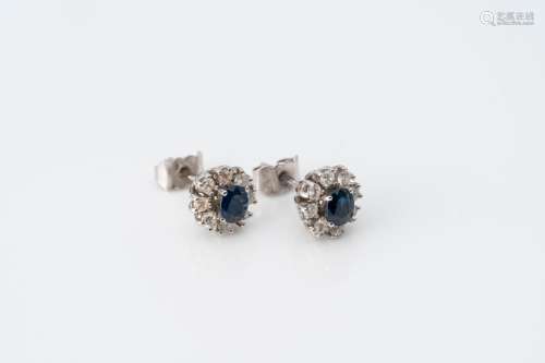 A pair of 18 carat white gold earrings set with two sapphire...