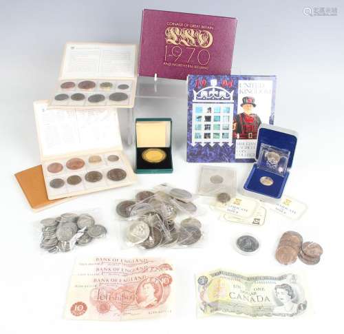 A group of British and world coins and banknotes, including ...