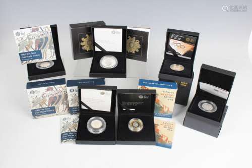A collection of Royal Mint deluxe-cased silver commemorative...