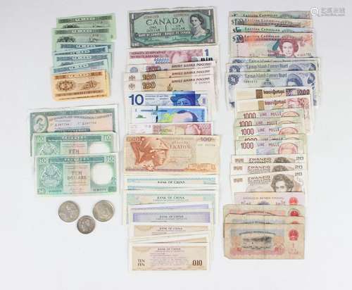 A group of various world banknotes, including a Hong Kong &a...