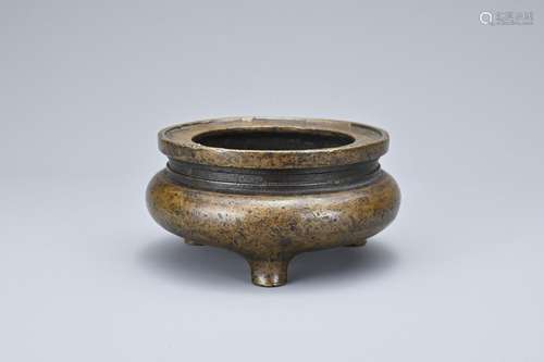 A CHINESE BRONZE TRIPOD CENSER